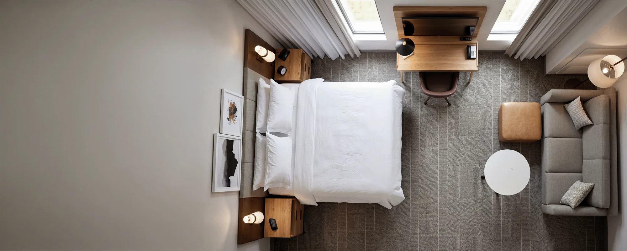 Modern hotel guestroom with wood case goods and upholstered seating