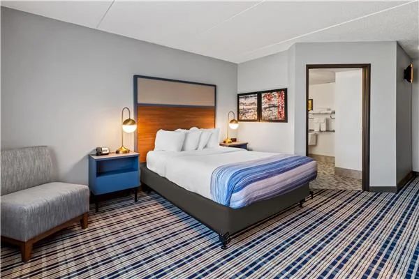AmericInn by Wyndham Crookston — headboard and nightstand detail