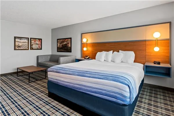 AmericInn by Wyndham Crookston — king room with coffee table and seating