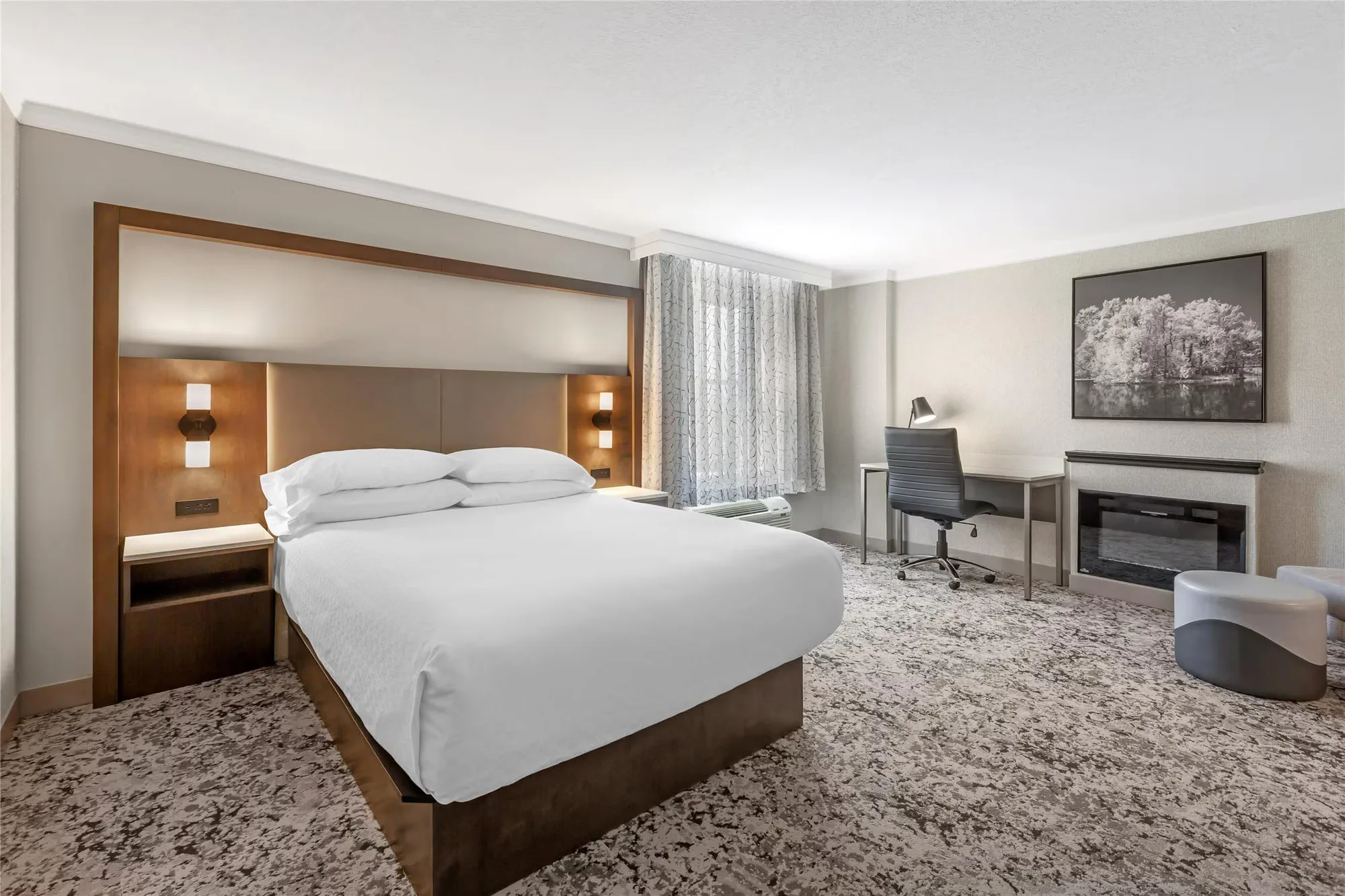 Best Western Plus The Arden Park Hotel — king guestroom with wood headboard, desk and fireplace surround