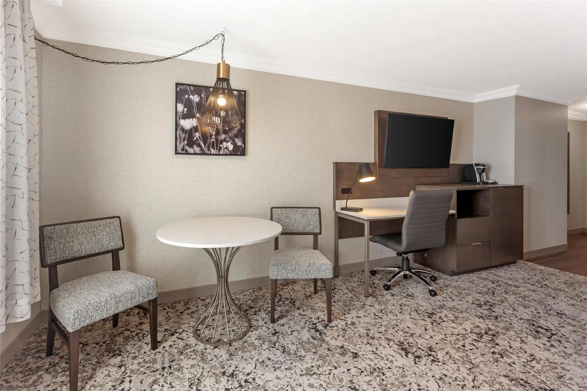 Best Western Plus The Arden Park Hotel — guestroom work area with upholstered bench, accent chair and TV console