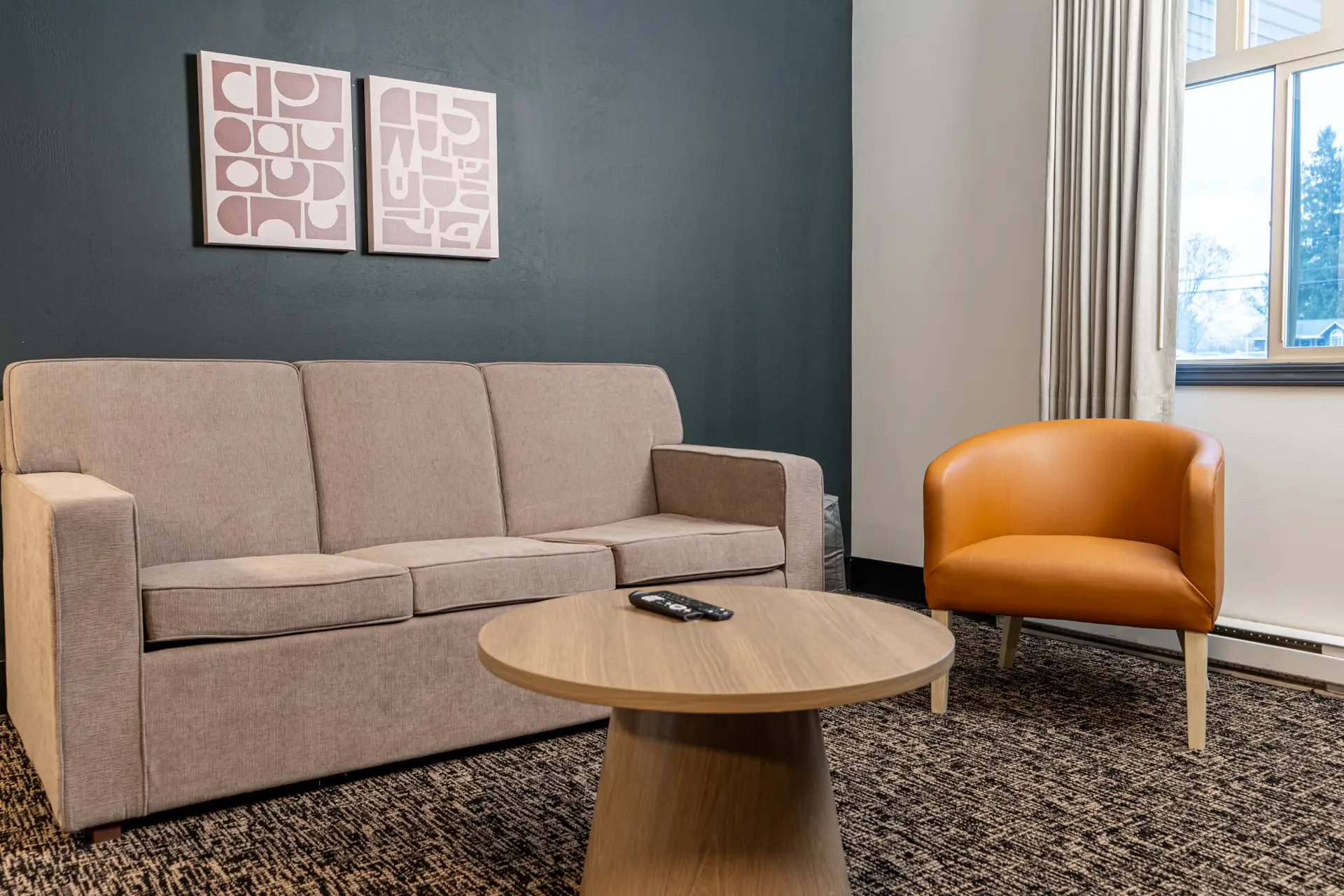 Hotel suite lounge with a Nerval sofa, accent chair and coffee table