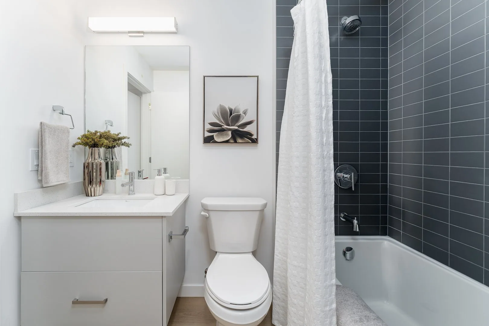 Hotel bathroom with shower doors and hardware by Nerval FF&E