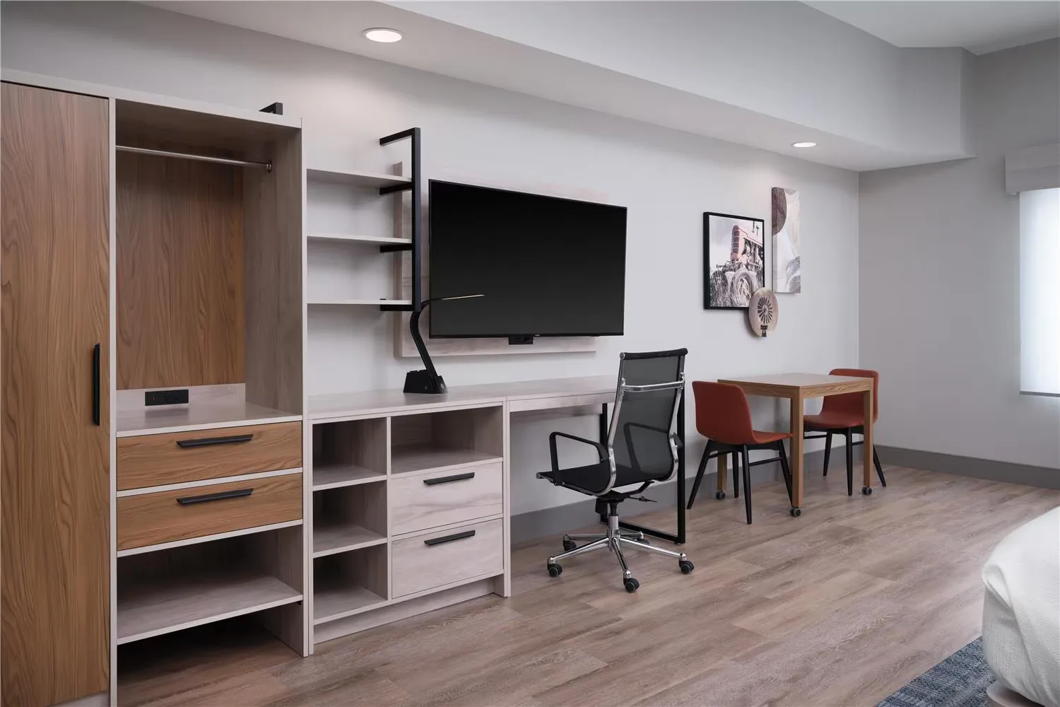 @HOME by Best Western Walkerton — open closet, drawer storage and desk with dining table beyond