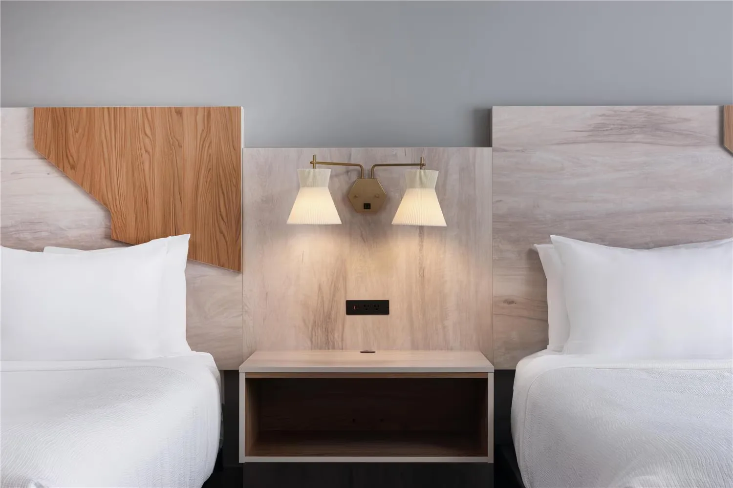 @HOME by Best Western Walkerton — double-queen headboard detail with shared nightstand and sconce