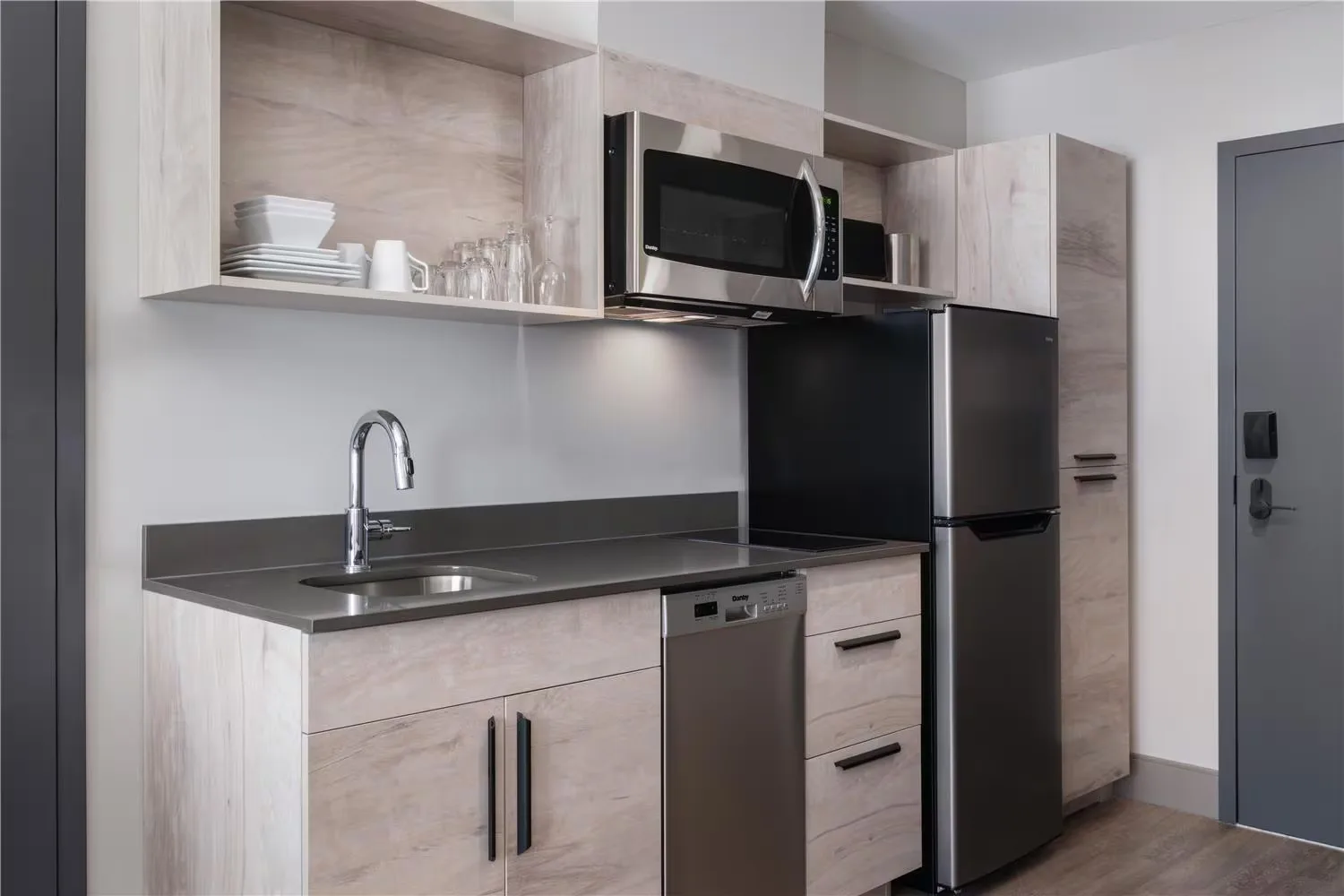 @HOME by Best Western Walkerton — extended-stay kitchenette with cabinetry, microwave and full-height fridge