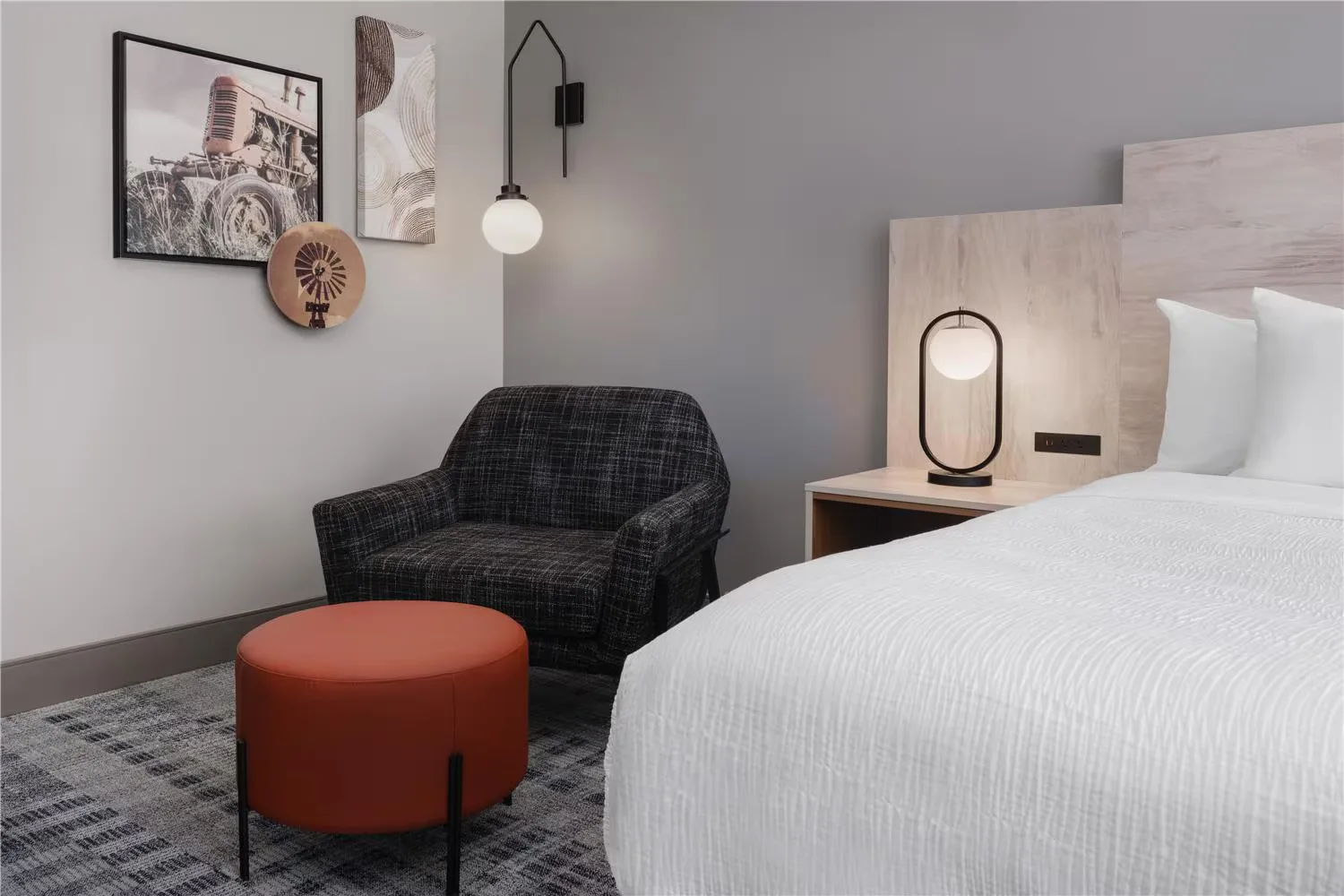 @HOME by Best Western Walkerton — guestroom lounge chair and ottoman beside the bed